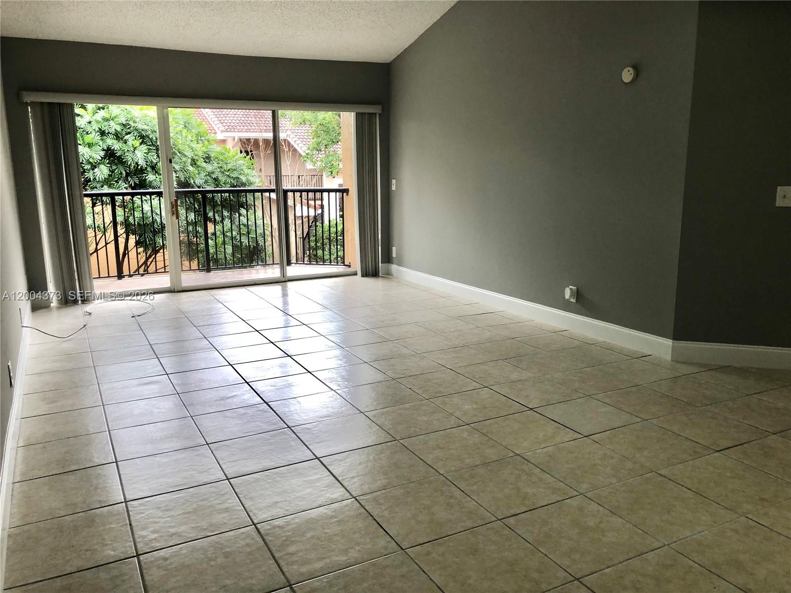 8761 Wiles Road, Unit 306 Coral Springs, FL 33067 - Photo 9 of 26 a view of an empty room and a window