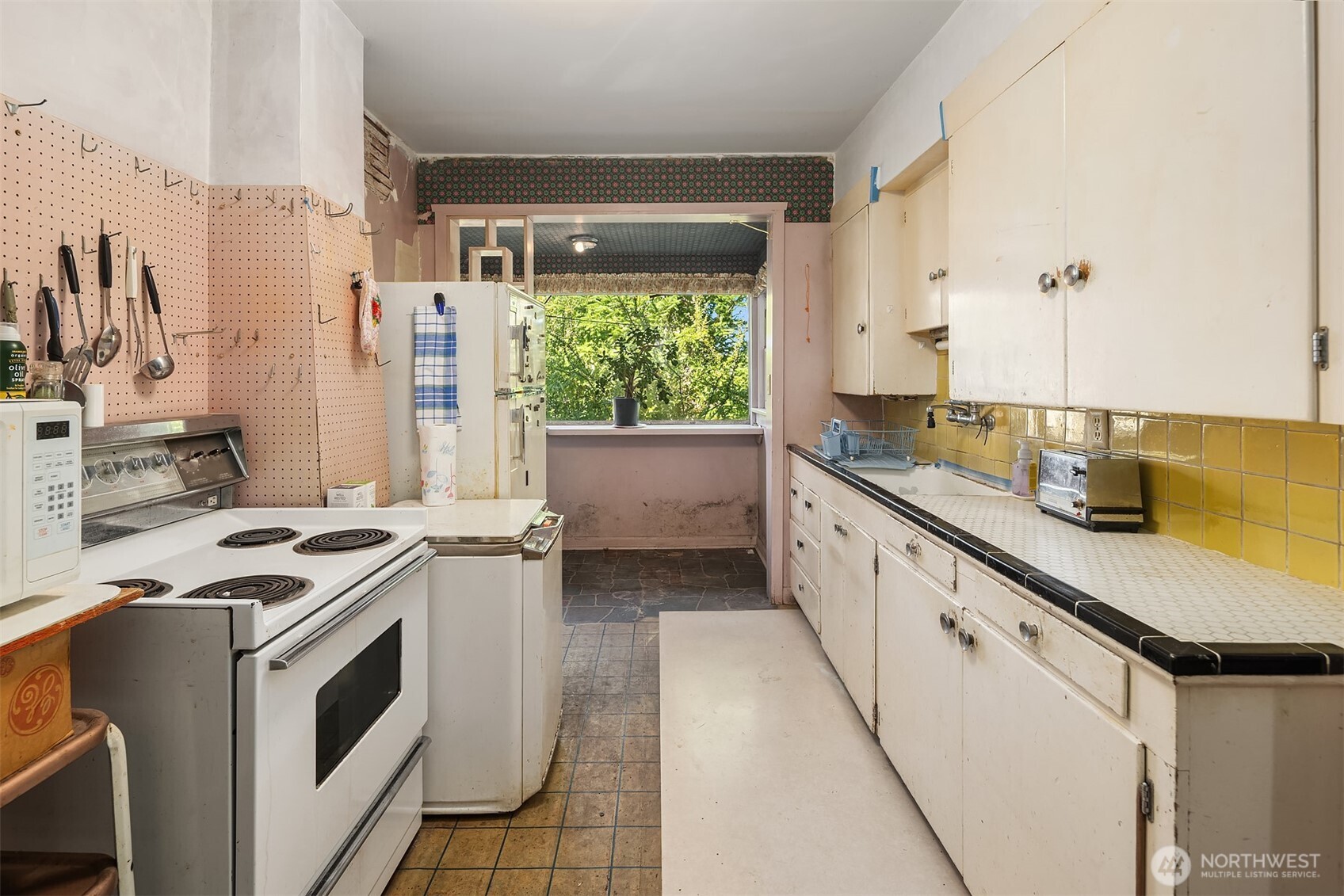 5202 35th Avenue Southwest Seattle, WA 98126 - Photo 16 of 32 a kitchen with a sink stove and cabinets