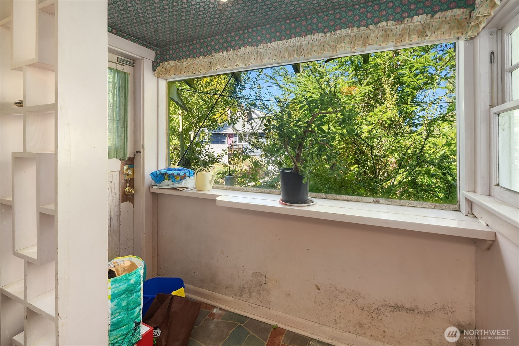 5202 35th Avenue Southwest Seattle, WA 98126 - Photo 19 of 32 a vase of flowers sitting on a window sill and a sink