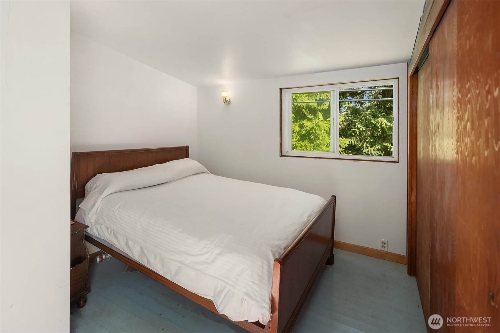 5202 35th Avenue Southwest Seattle, WA 98126 - Photo 22 of 32 a bed sitting in a bedroom next to a window