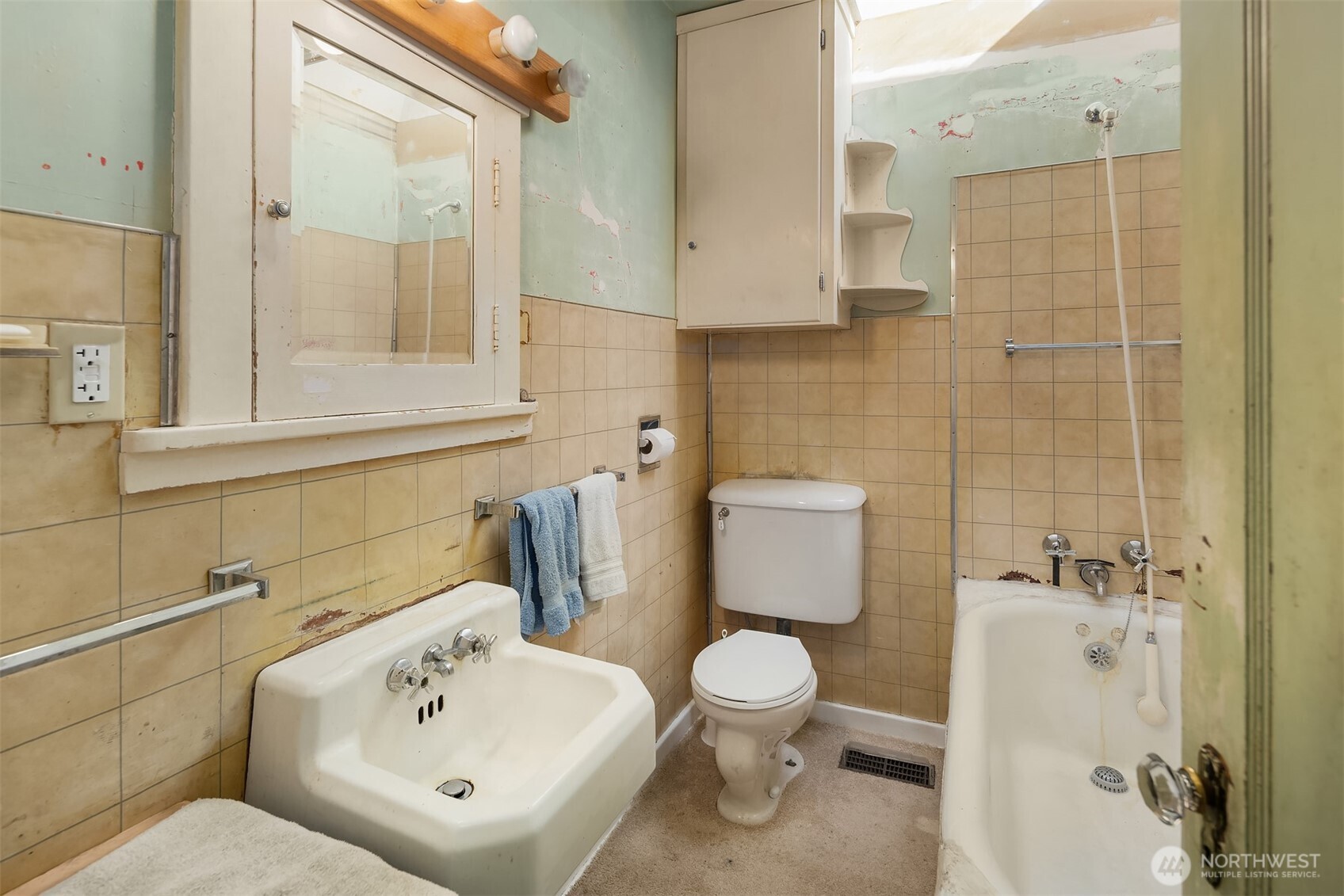5202 35th Avenue Southwest Seattle, WA 98126 - Photo 23 of 32 a white toilet sitting next to a bathroom sink
