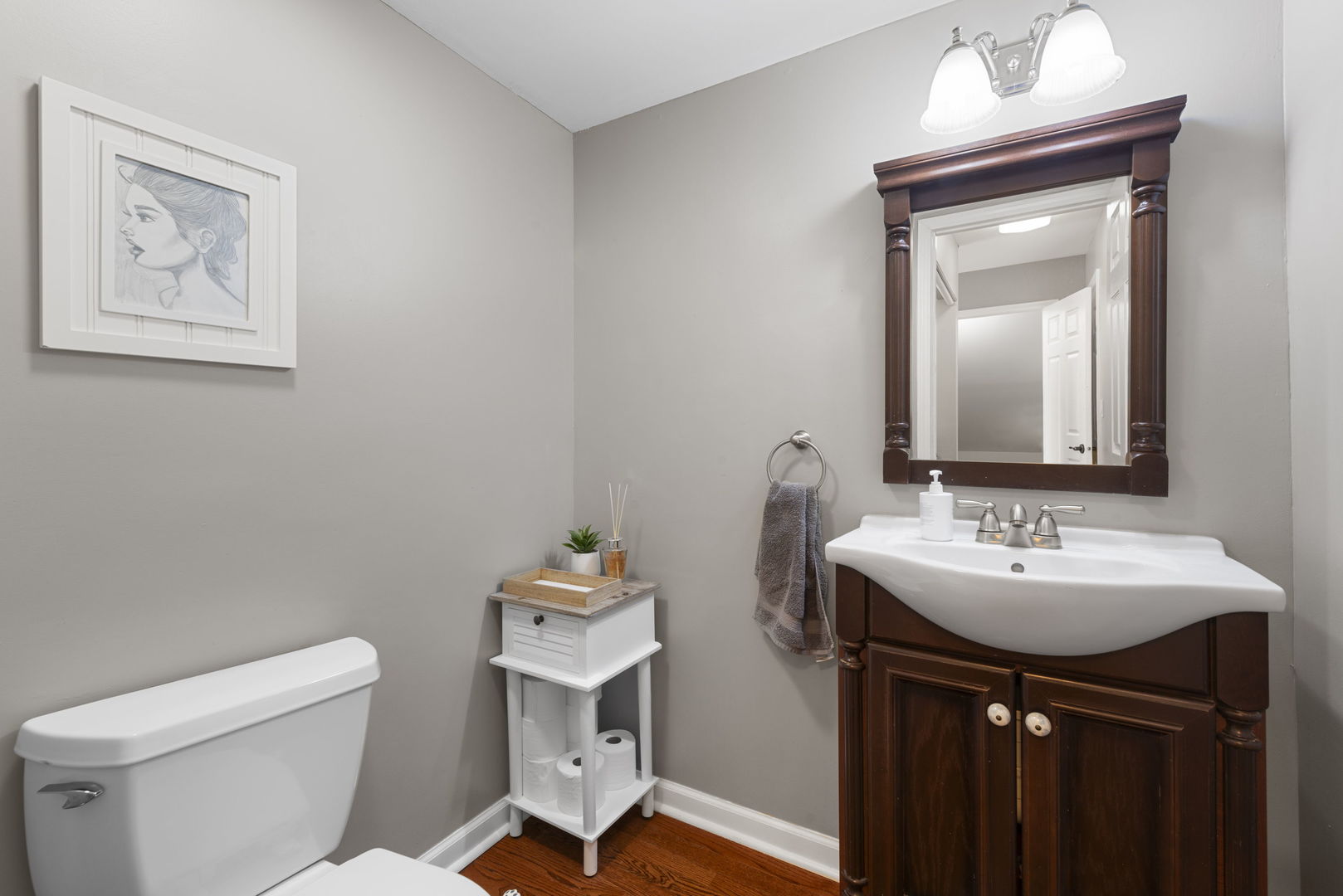 4599 Mumford Drive Hoffman Estates, IL 60192 - Photo 16 of 25 a bathroom with a toilet sink and mirror