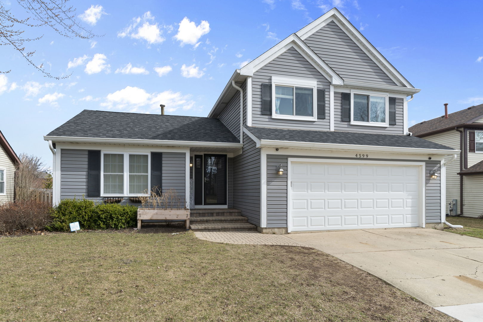 4599 Mumford Drive Hoffman Estates, IL 60192 - Photo 2 of 25 a front view of a house with a yard and garage