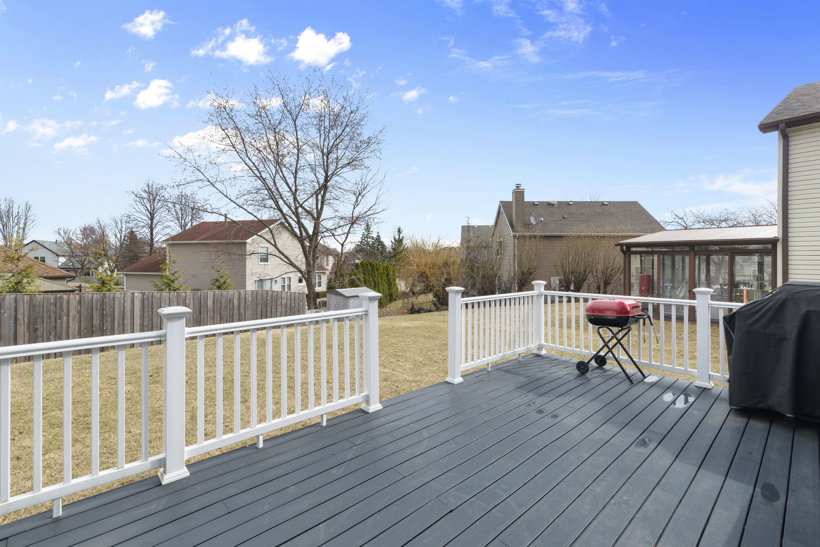 4599 Mumford Drive Hoffman Estates, IL 60192 - Photo 23 of 25 a roof deck with table and chairs a barbeque with wooden floor and fence