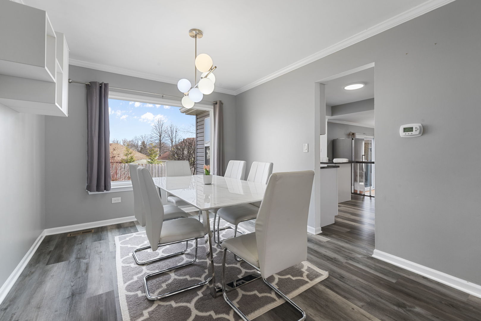 4599 Mumford Drive Hoffman Estates, IL 60192 - Photo 3 of 25 a view of a dining room with furniture wooden floor and chandelier