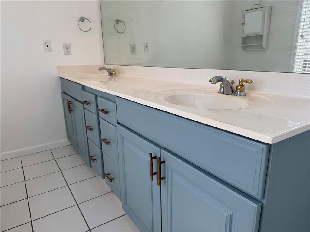 2075 Pine Tree Drive Buford, GA 30518 - Photo 12 of 18 a bathroom with a sink a mirror and vanity