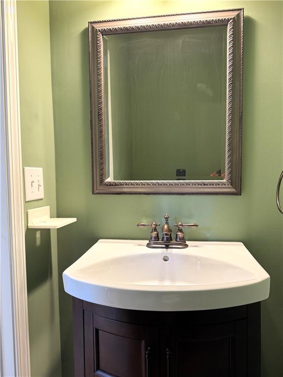 2075 Pine Tree Drive Buford, GA 30518 - Photo 16 of 18 a bathroom with a sink and a mirror