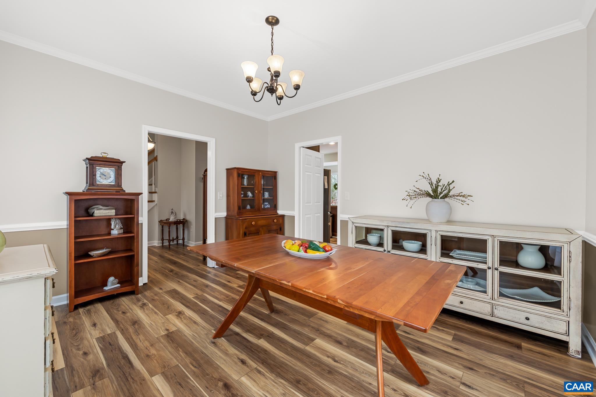 334 Carodon Drive Ruckersville, VA 22968 - Photo 17 of 54 a living room with furniture a dining table and chairs with wooden floor