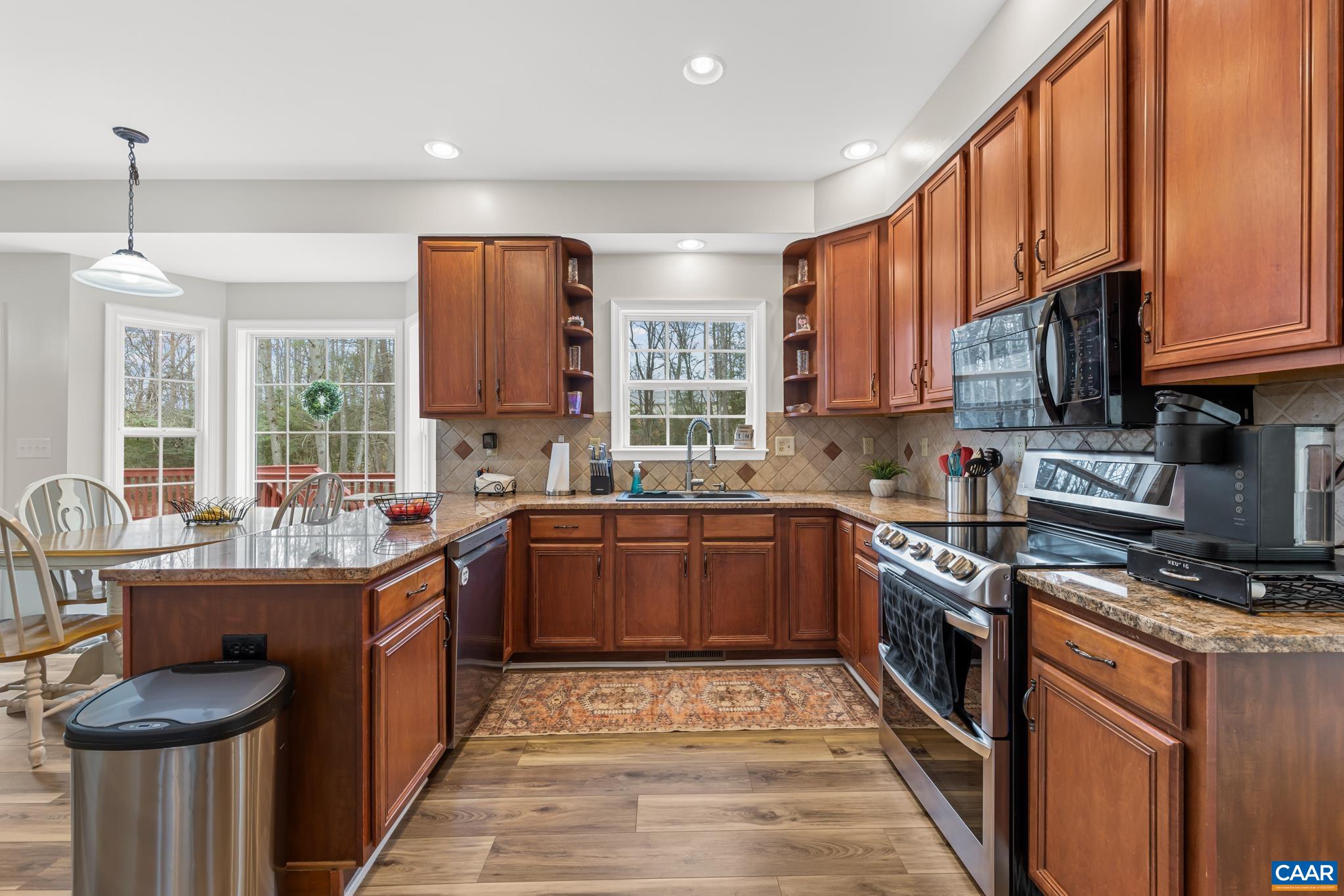 334 Carodon Drive Ruckersville, VA 22968 - Photo 18 of 54 a kitchen with stainless steel appliances granite countertop a stove a sink dishwasher and a refrigerator