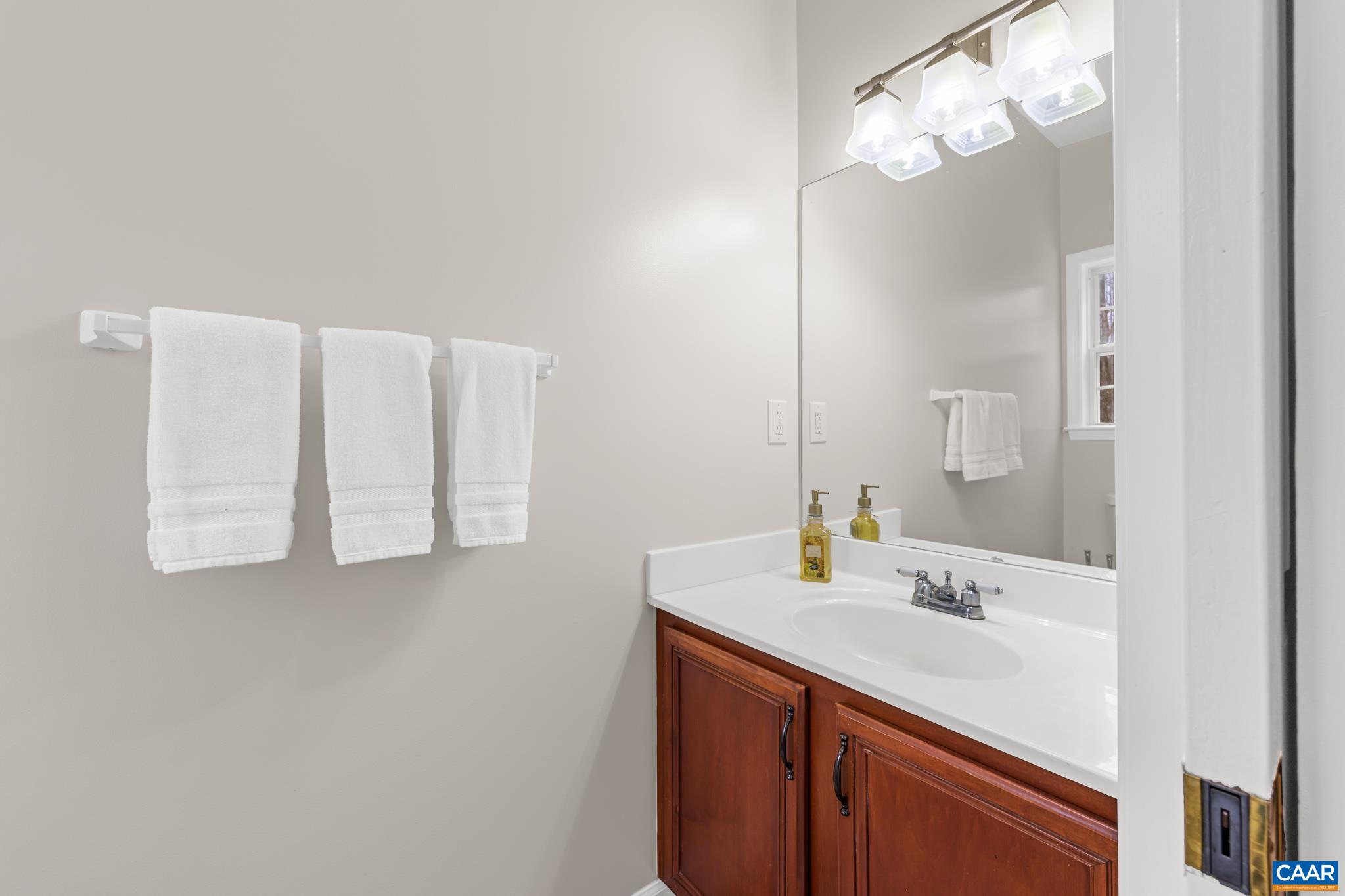 334 Carodon Drive Ruckersville, VA 22968 - Photo 26 of 54 a bathroom with a sink vanity and a mirror
