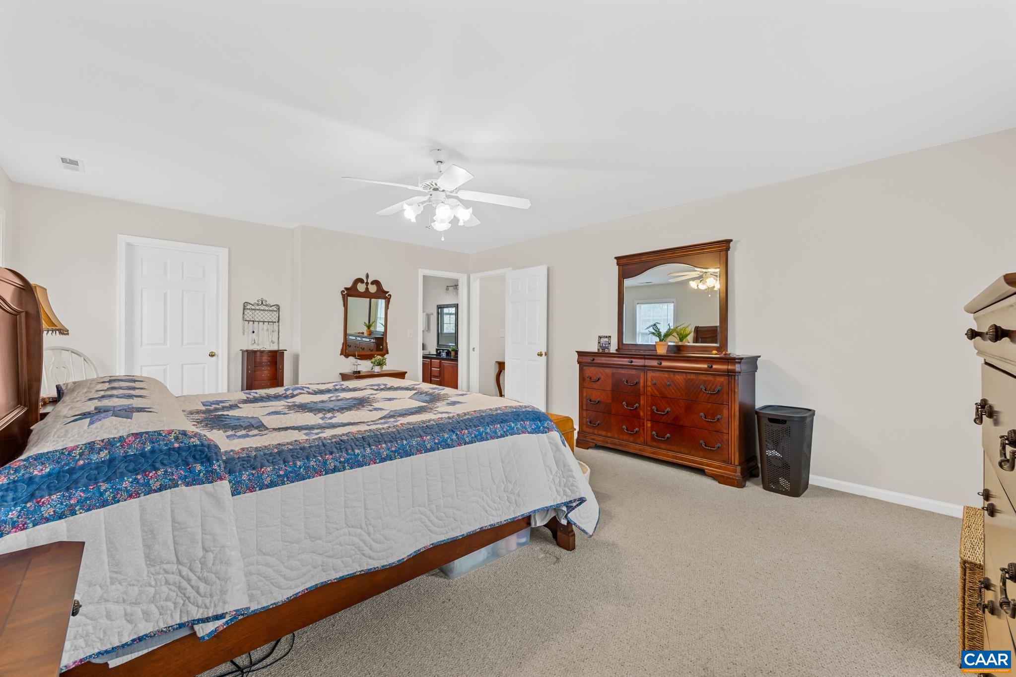 334 Carodon Drive Ruckersville, VA 22968 - Photo 29 of 54 a bedroom with a bed and a chandelier