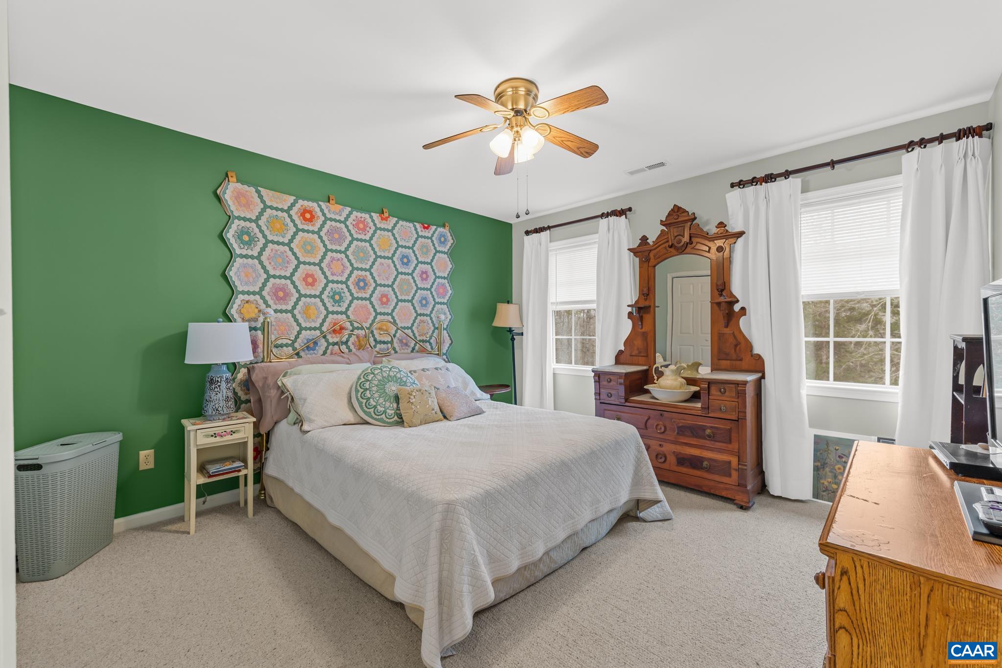 334 Carodon Drive Ruckersville, VA 22968 - Photo 32 of 54 a bedroom with a bed and a chandelier