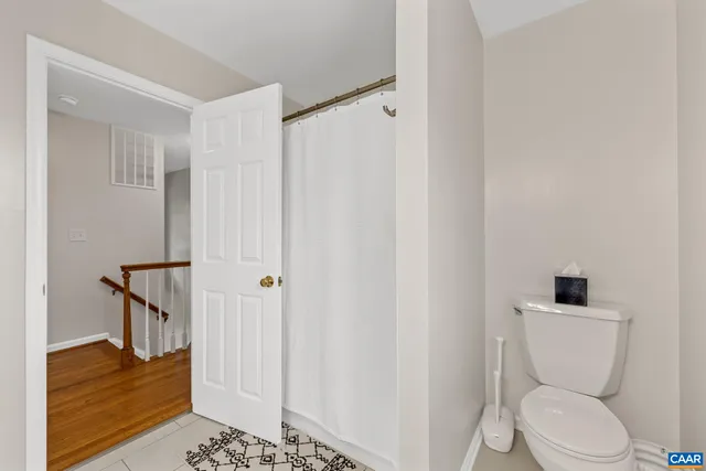 a kitchen with a refrigerator and white cabinets