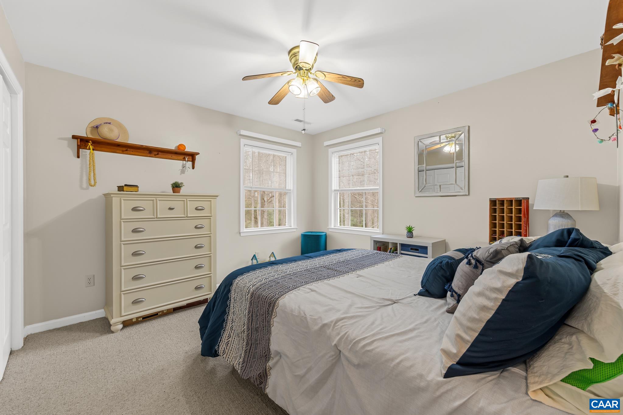 334 Carodon Drive Ruckersville, VA 22968 - Photo 36 of 54 a bedroom with a bed and a chandelier
