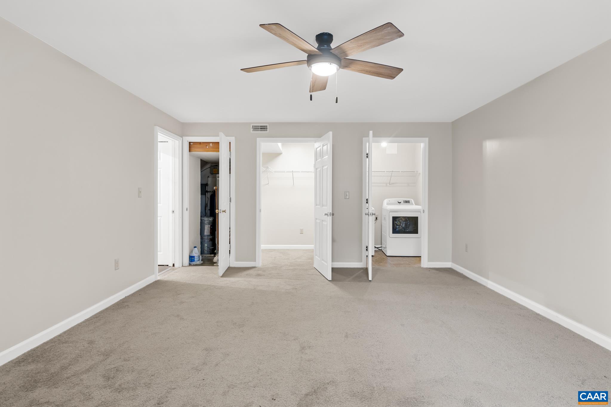 334 Carodon Drive Ruckersville, VA 22968 - Photo 44 of 54 an empty room with chandelier fan and windows