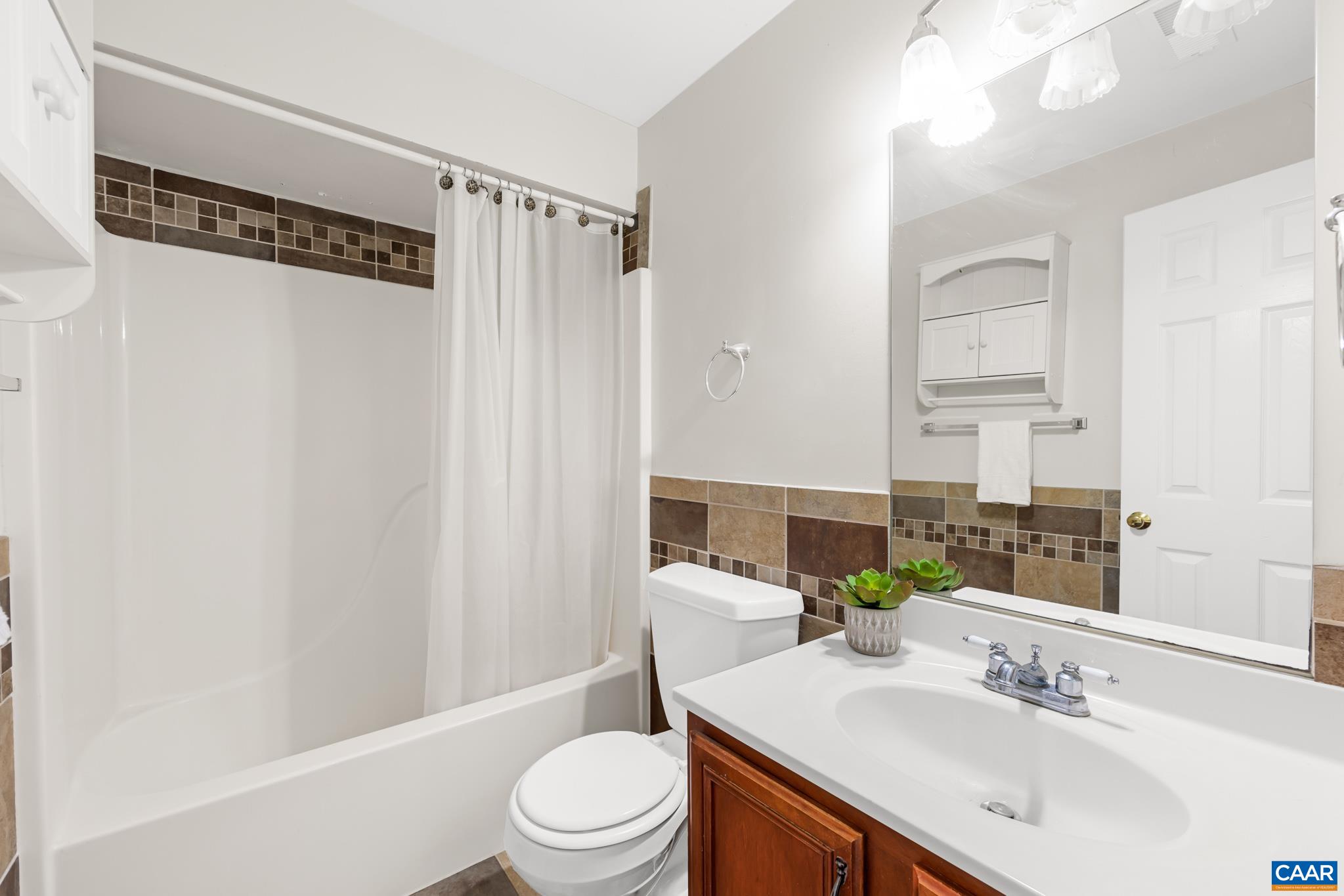 334 Carodon Drive Ruckersville, VA 22968 - Photo 47 of 54 a bathroom with a sink a toilet and shower