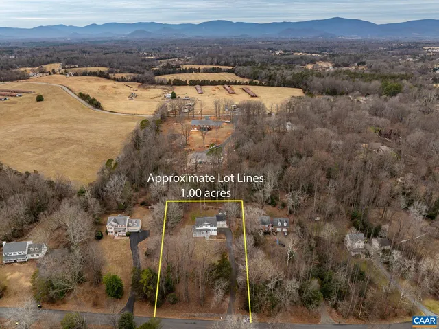 an aerial view of town with residential houses and mountain view