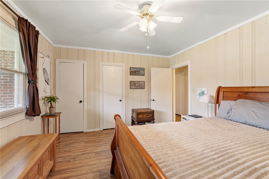 1105 Greenacres Anderson, SC 29621 - Photo 26 of 46 A comforting bedroom space features plank flooring and a ceiling fan, offering a serene retreat.