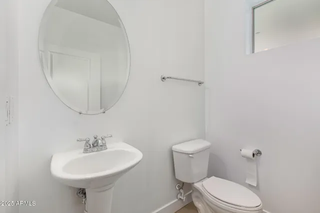 a bathroom with a sink a mirror and a toilet