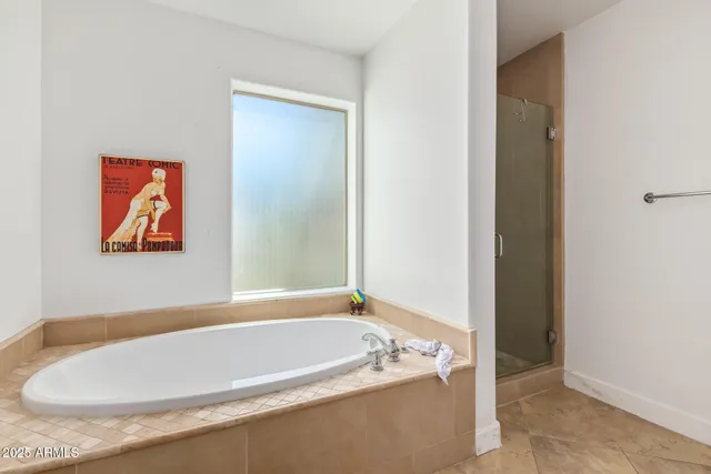 a bathroom with a tub and shower