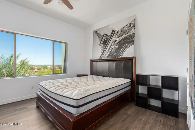 a bed sitting in a bedroom next to a window