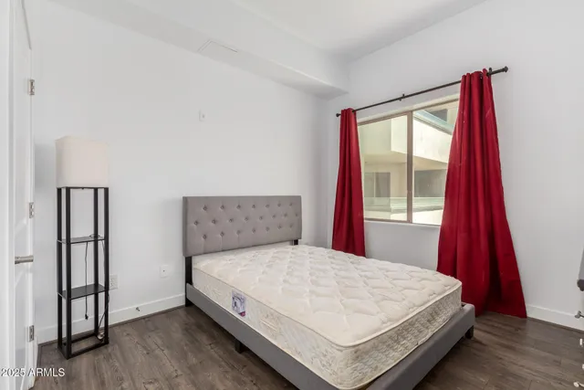 a bed sitting in a bedroom next to a window