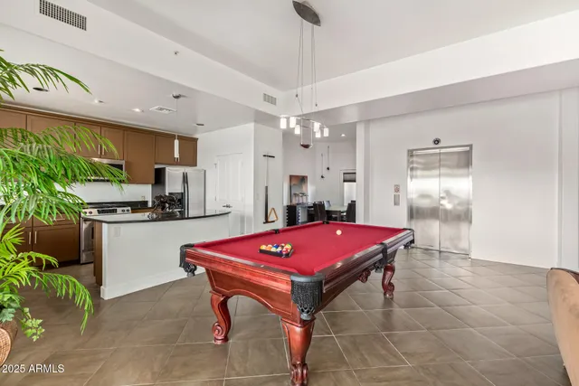 a kitchen with a refrigerator a stove a sink dishwasher with a dining table and chairs