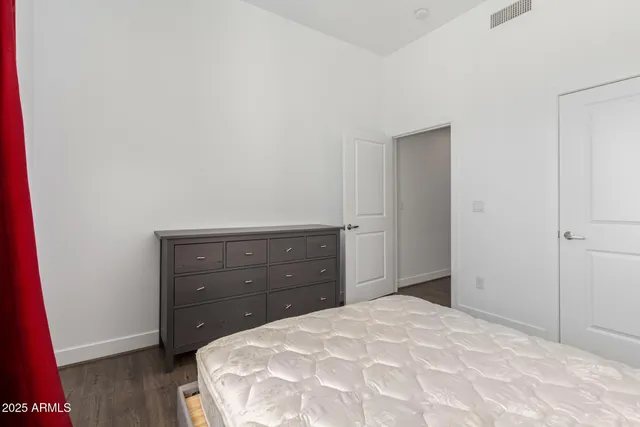 a bedroom with a bed and a dresser