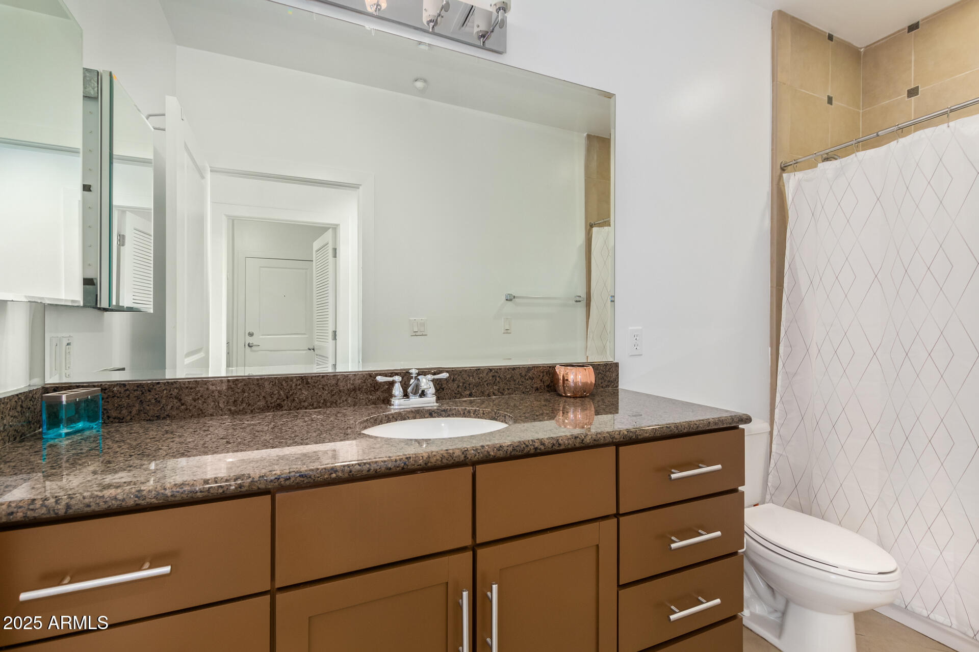 945 East Playa Del Norte Drive, Unit 3004 Tempe, AZ 85288 - Photo 23 of 41 a bathroom with a granite countertop sink and a mirror