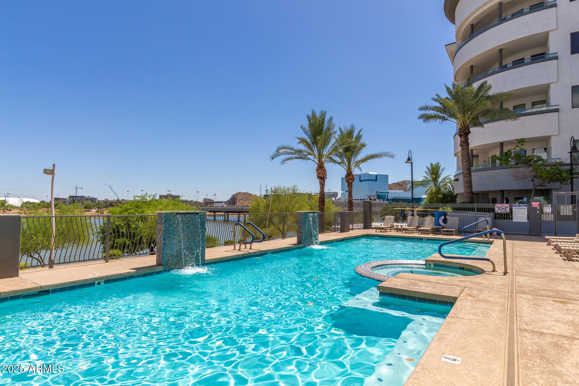 945 East Playa Del Norte Drive, Unit 3004 Tempe, AZ 85288 - Photo 31 of 41 a view of a swimming pool with a patio and a garden