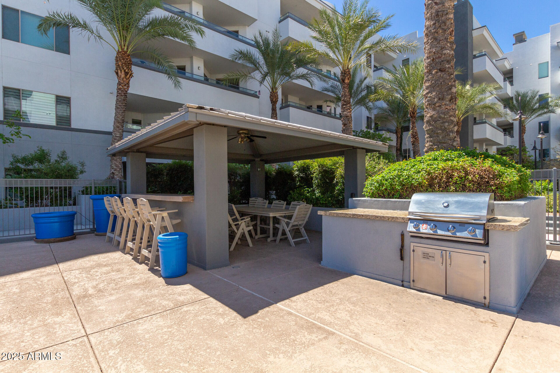945 East Playa Del Norte Drive, Unit 3004 Tempe, AZ 85288 - Photo 34 of 41 a view of a patio with a dining table and chairs with wooden fence