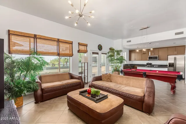 a living room with furniture and a floor to ceiling window