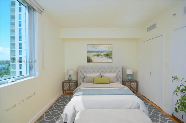 a bedroom with a bed and painting on the wall