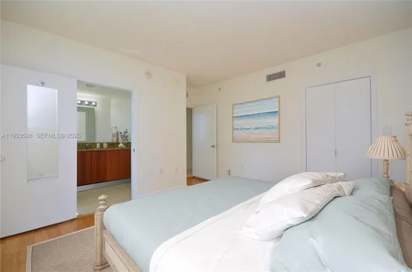 a bedroom with a bed and a view of bathroom