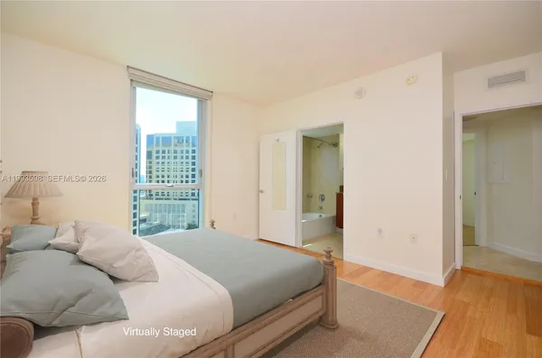 a bedroom with a bed and a window