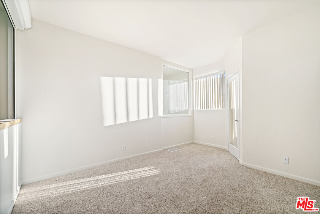 2045 Beloit Avenue, Unit 306 Los Angeles, CA 90025 - Photo 12 of 14 a view of an empty room with a window
