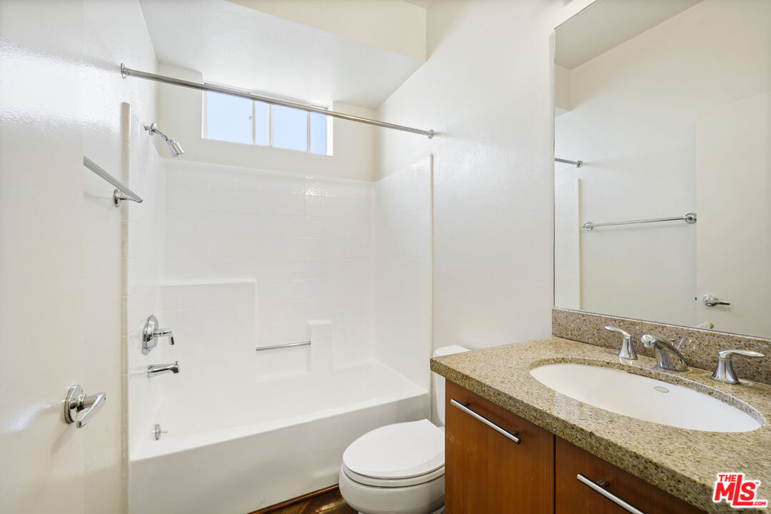 2045 Beloit Avenue, Unit 306 Los Angeles, CA 90025 - Photo 6 of 14 a bathroom with a granite countertop sink toilet and shower