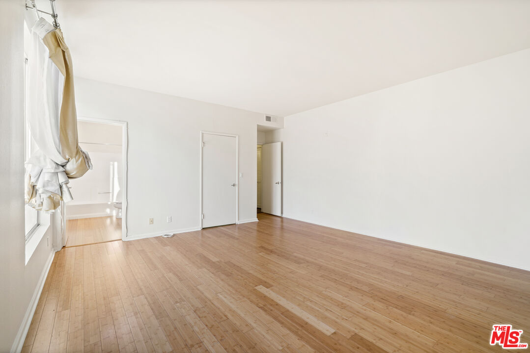 2045 Beloit Avenue, Unit 306 Los Angeles, CA 90025 - Photo 8 of 14 a view of empty room with wooden floor and fan