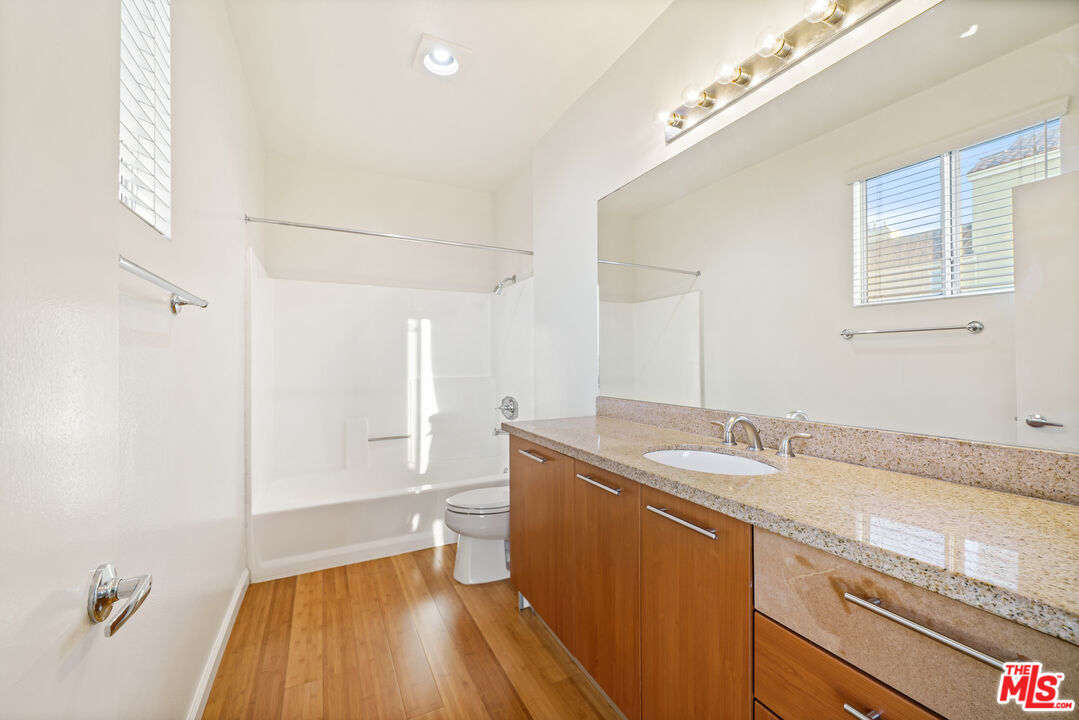 2045 Beloit Avenue, Unit 306 Los Angeles, CA 90025 - Photo 9 of 14 a bathroom with a sink and a mirror