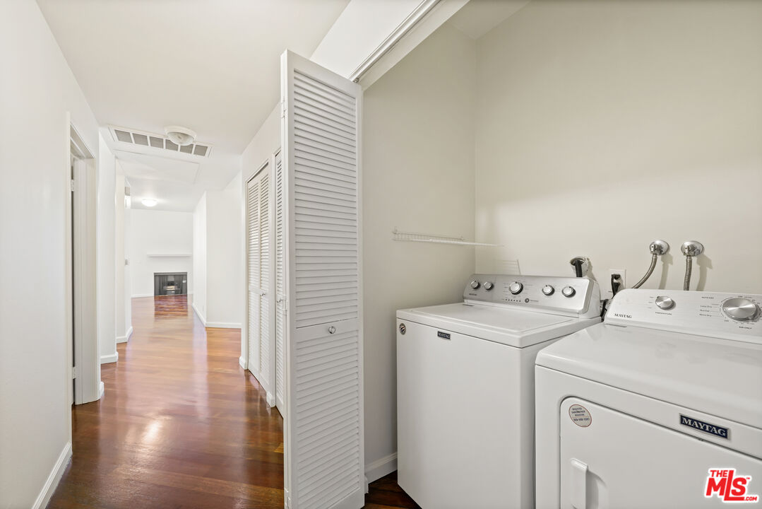 2045 Beloit Avenue, Unit 306 Los Angeles, CA 90025 - Photo 10 of 14 a view of washer and dryer with bathroom in the background