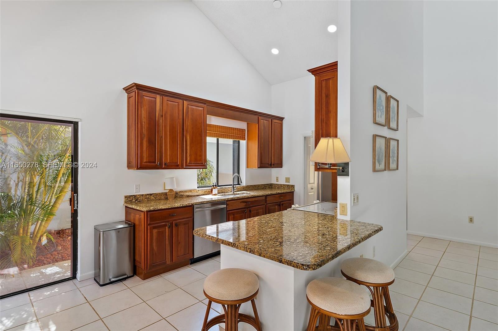 101 Sand Pine Drive, Unit 101 Jupiter, FL 33477 - Photo 14 of 47 a kitchen with a table chairs and a refrigerator