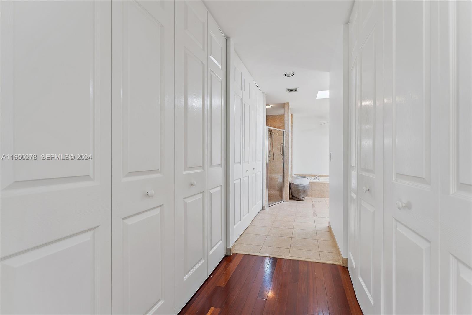 101 Sand Pine Drive, Unit 101 Jupiter, FL 33477 - Photo 28 of 47 a view of a hallway with wooden floor