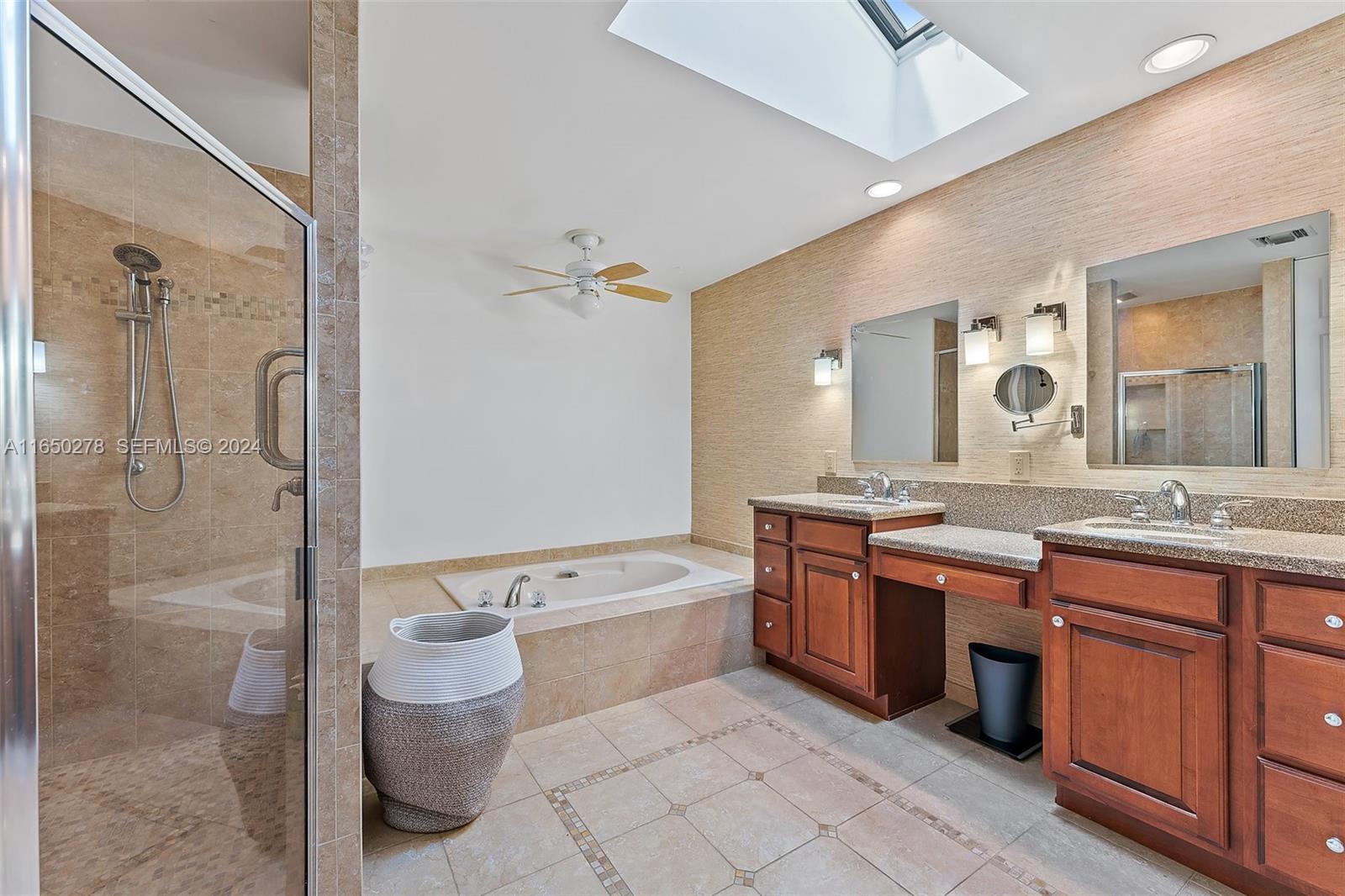101 Sand Pine Drive, Unit 101 Jupiter, FL 33477 - Photo 29 of 47 a bathroom with a granite countertop double vanity sink toilet mirror and bathtub