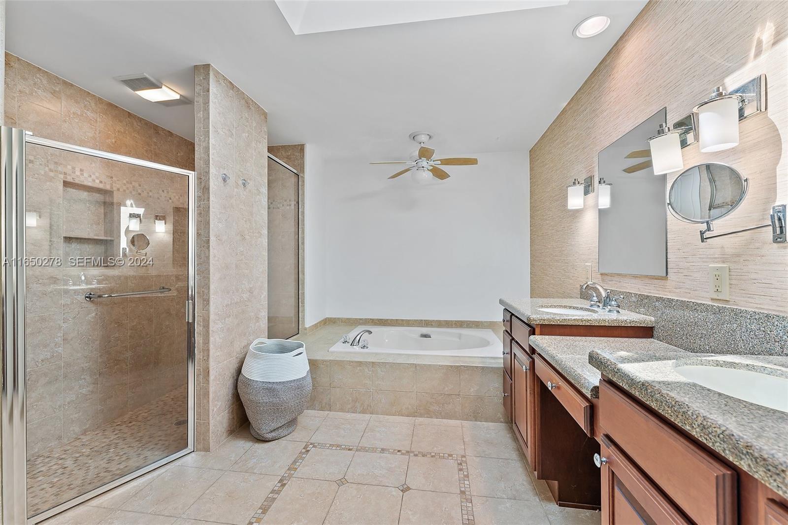 101 Sand Pine Drive, Unit 101 Jupiter, FL 33477 - Photo 30 of 47 a spacious bathroom with a granite countertop sink a toilet and shower