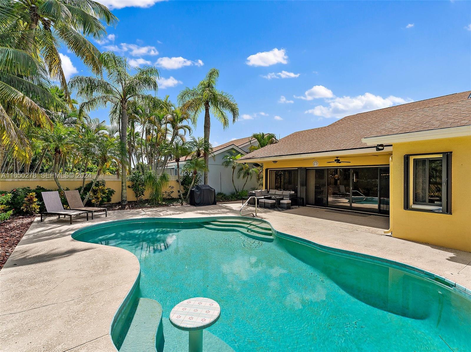 101 Sand Pine Drive, Unit 101 Jupiter, FL 33477 - Photo 3 of 47 a view of a house with swimming pool and sitting area