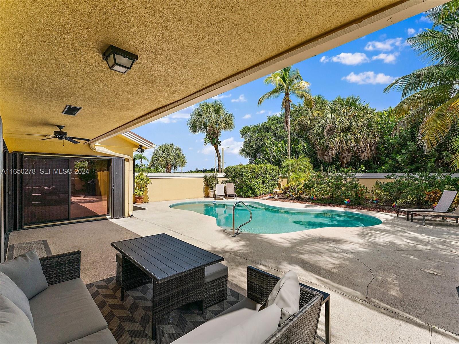 101 Sand Pine Drive, Unit 101 Jupiter, FL 33477 - Photo 38 of 47 a outdoor living space with furniture and a yard