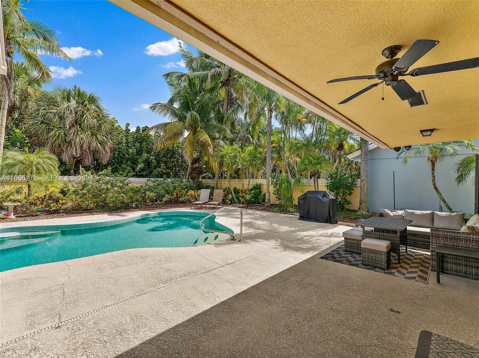 101 Sand Pine Drive, Unit 101 Jupiter, FL 33477 - Photo 39 of 47 a backyard of a house with table and chairs