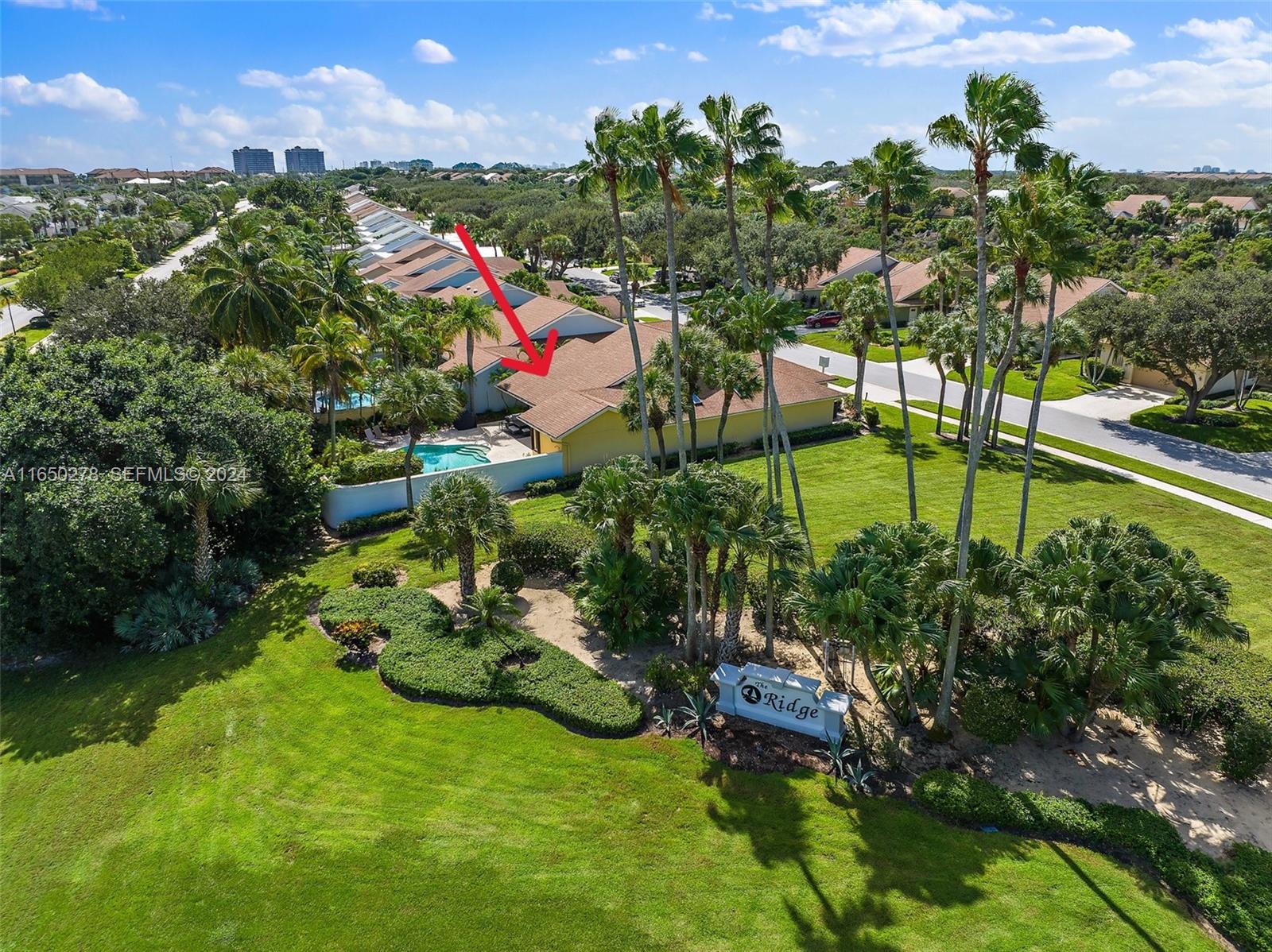 101 Sand Pine Drive, Unit 101 Jupiter, FL 33477 - Photo 4 of 47 a view of a garden with a building in the background