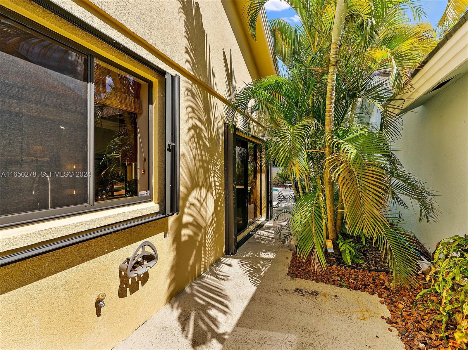 101 Sand Pine Drive, Unit 101 Jupiter, FL 33477 - Photo 44 of 47 a view of a door with a tree