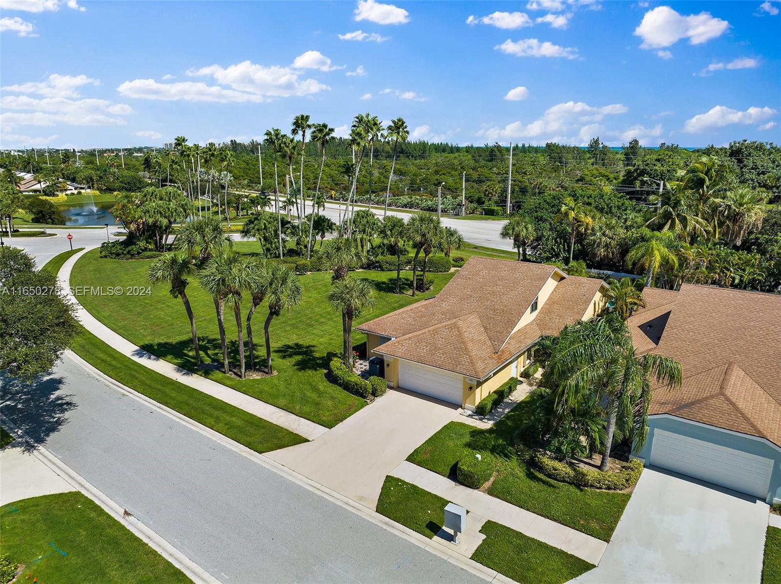 101 Sand Pine Drive, Unit 101 Jupiter, FL 33477 - Photo 47 of 47 an aerial view of a house with a garden and trees